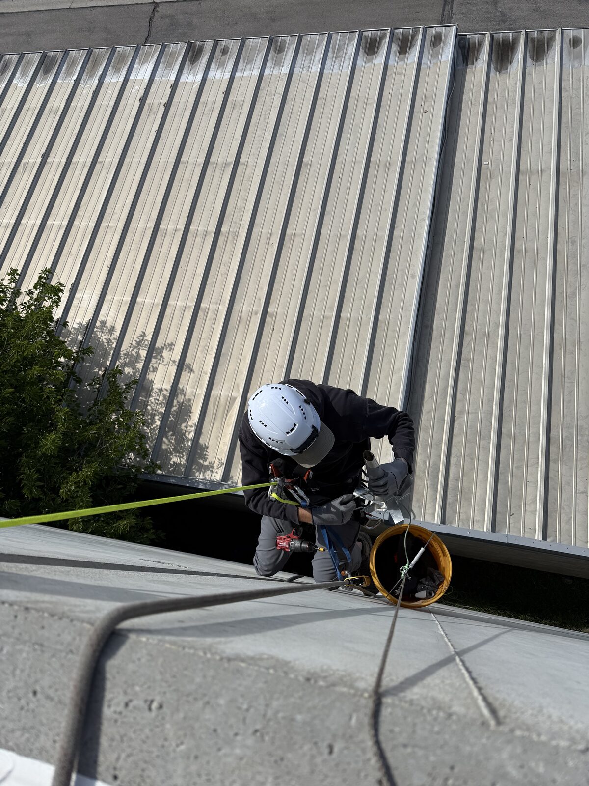 Technician completing exterior repairs above ladder reach