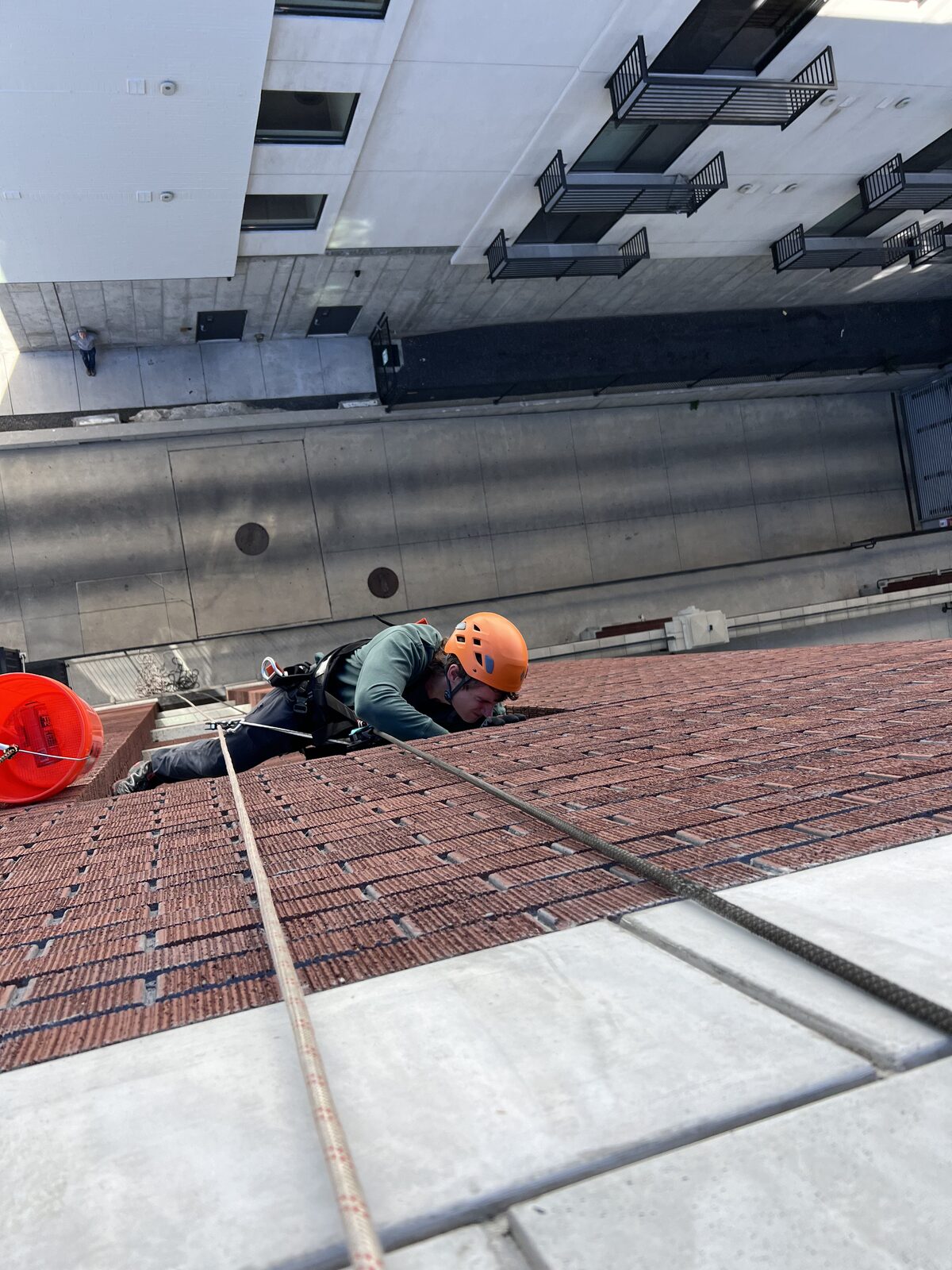 Rope-access inspection of a brick commercial exterior